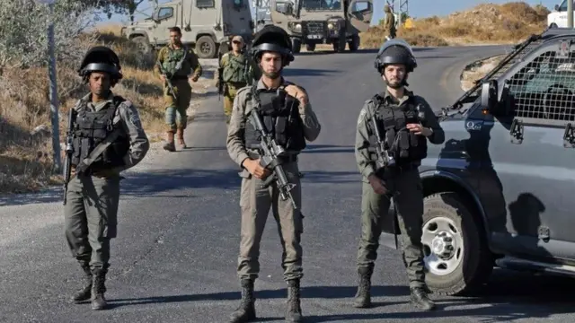 جنود إسرائيليون يقفون في مكان العثور على جثة الجندي