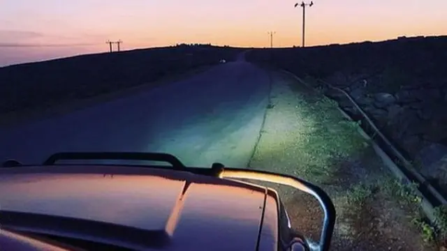 Car bonnet driving at dusk