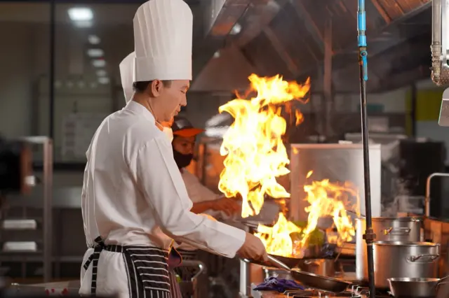 Chef team preparing food in the kitchen of a hotel restaurant