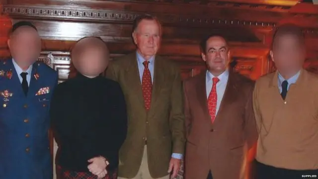 An interpreter, second left, says Mr Bush, centre, groped her in 2004