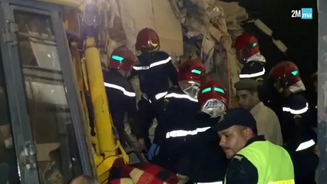 Civil protection members search for survivors near rubble in Chichaoua