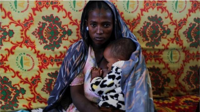 Niño que sostiene la alarma con las 7 en punto en la cara del