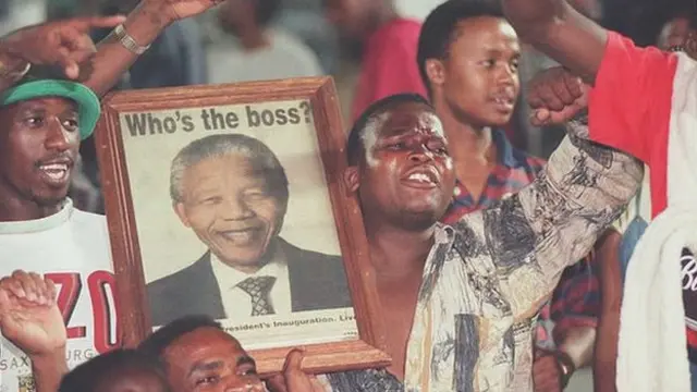 South Africa fans hold up a portrait of Nelson Mandela in the stands