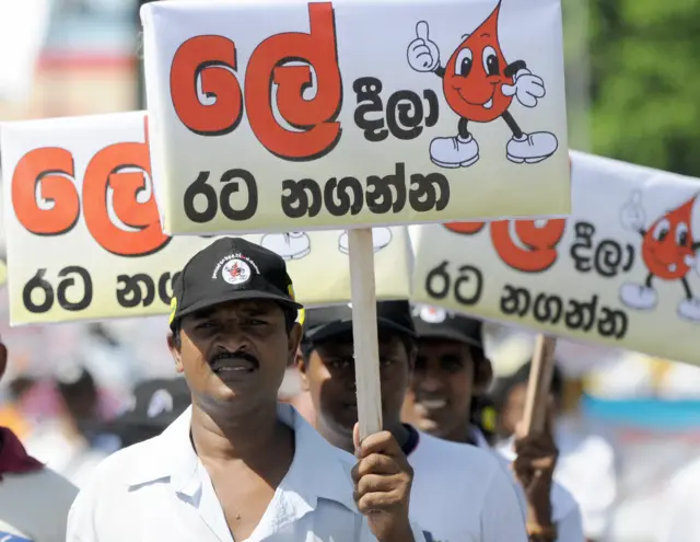 Sri Lankan volunteers carry placards encouraging blood donations during a march in Colombo on June 14, 2009, held to mark World Blood Donation Day. Hundreds of activists took part in the march in a country where many volunteered to donate blood during heavy fighting between troops and Tamil Tigers that ended in May after nearly four-decades of ethnic bloodshed.