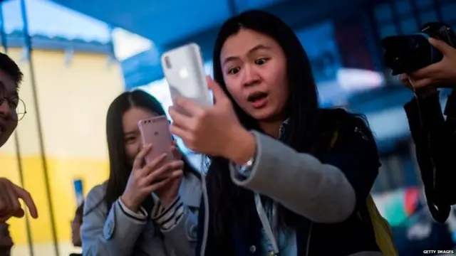 Picture of an iPhone user testing the facial ID feature