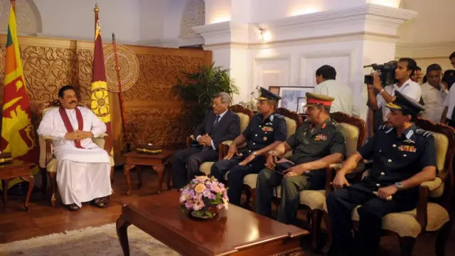 Sri Lankan President Mahinda Rajapaksa (L) is informed by the defence secretary, Gotabhaya Rajapakse (2L), Sri Lankan chief of staff Donald Perera (3L), army chief Lieutenantt General Sarath Fonseka (2R) and Sri Lankan Air Force chief Roshan Gunatilleke (R) that the against the Tamil Tiger rebels had ended successfully, in Colombo on May 18, 2009. Defence officials announced that Tamil Tiger leader Velupillai Prabhakaran and the entire rebel leadership had been killed on May 18, 2009 by government troops. AFP PHOTO/Lakruwan WANNIARACHCHI. (Photo credit should read LAKRUWAN WANNIARACHCHI/AFP/Getty Images)