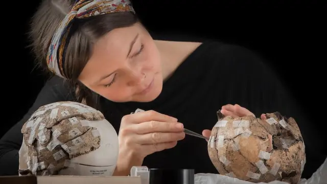 Clara Alfsdotter pieces together a skull found at the site