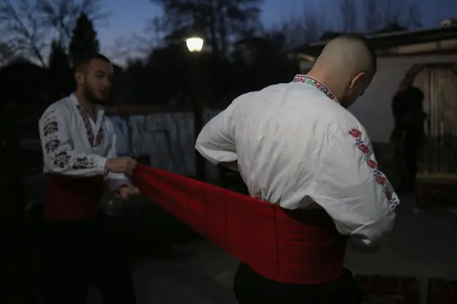 muškarci nose neizostavni pojas oko struka, takozvani trombolos koji je nekada bio rasprostranjen širom Balkanskog poluostrva.