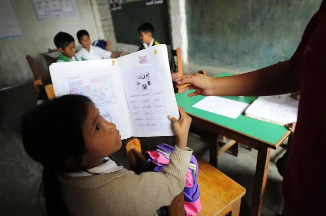 Un alumno muestra su cuaderno