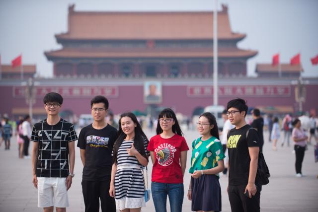 People pose for a photograph at the Tiananmen square - China's symbolic political heart - prior to the 27th anniversary of what some people refer to as the "June 4 massacre, in Beijing on June 4, 2016, China.