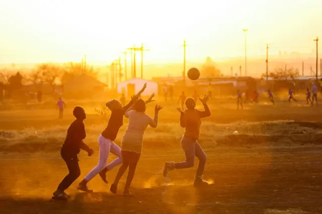 The members of the "Happy girls" netball team take part in a practice session at Katlehong township, south-east of Johannesburg.