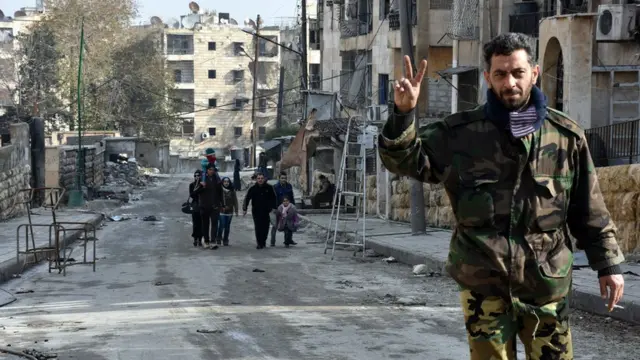 Un soldado sirio hace el signo de la victoria en Alepo.
