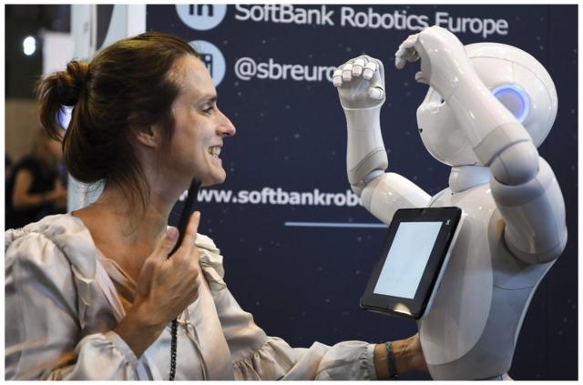 A woman plays with a robot at the Softbank Robotics exhibition stand during the VivaTech trade fair, on May 24, 2018 in Paris. / AFP PHOTO / ALAIN JOCARDALAIN JOCARD/AFP/Getty Images