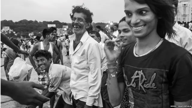 Men laughing while celebrating Ganesh Chaturthi, a Hindu festival
