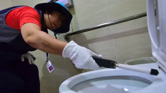 البحث عن كاميرا مخبأة في أحد الحمامات العامة في سول