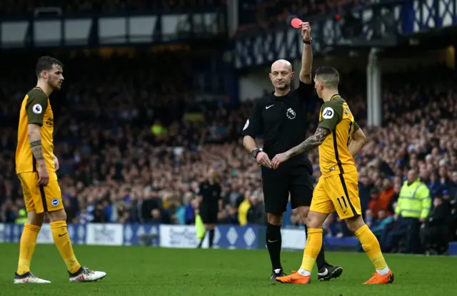 Anthony Knockaert of Brighton and Hove Albion is shown a red card by referee