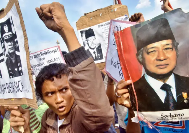 Indonesian students hold a rally as they protest against the decision to drop the graft case against former dictator Suharto (pictured R), in front of the Presidential Palace in Jakarta, 18 May 2006. A graft case against Suharto, who is accused of embezzling billions of dollars of state assets during his 32-year rule, has been dropped due to his deteriorating health