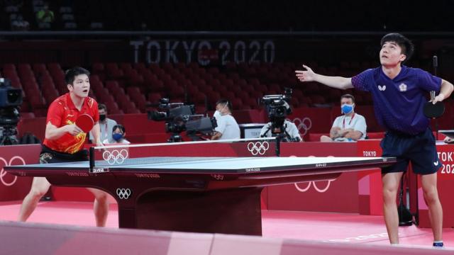 an Zhendong of China (L) in action against Lin Yun Ju of Chinese Taipei (R) during the Table Tennis Men"s Singles Semifinal of the Tokyo 2020 Olympic Games at the Tokyo Metropolitan Gymnasium arena in Tokyo, Japan, 29 July 2021