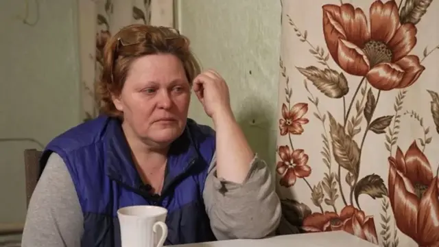 Olga sitting at a kitchen table