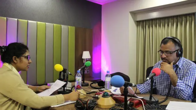 বাংলাদেশে ২০১৮ সালের সংসদ নির্বাচনের সময় ঢাকায় বিবিসি বাংলার অস্থায়ী স্টুডিওতে অনুষ্ঠান পরিবেশন করছেন ফারহানা পারভীন আর মিজান খান।