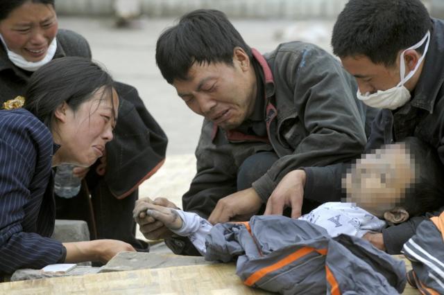 2008年5月15日，映秀，亲属围着一名遇难的孩子痛哭。