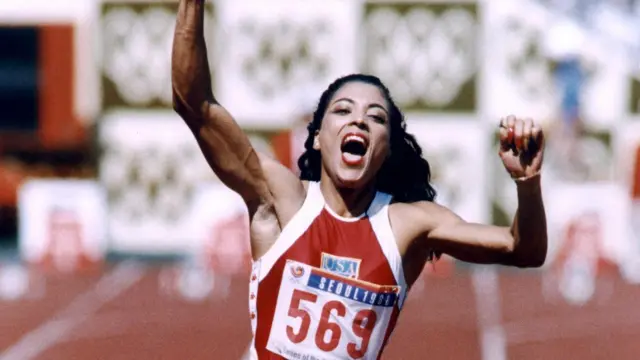 The American Florence Griffith Joyner raises her arms in jubilation, 25 September 1988, after setting a new Olympic record to win the gold medal in the women"s 100 meters dash final at the Seoul Olympic Games