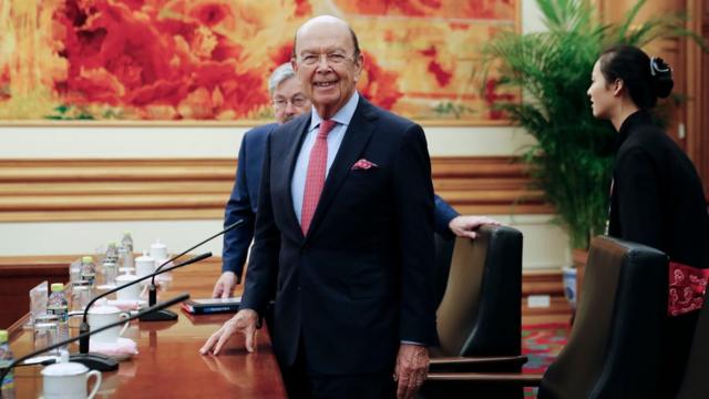 US Commerce Secretary Wilbur Ross (C) is accompanied by US Ambassador to China Terry Branstad as they arrive for a bilateral meeting with Chinese Vice Premier Wang Yang at the Zhongnanhai Leadership Compound in Beijing on September 25, 2017