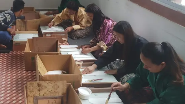 Arya Yogini and female workers make sanitary pads.