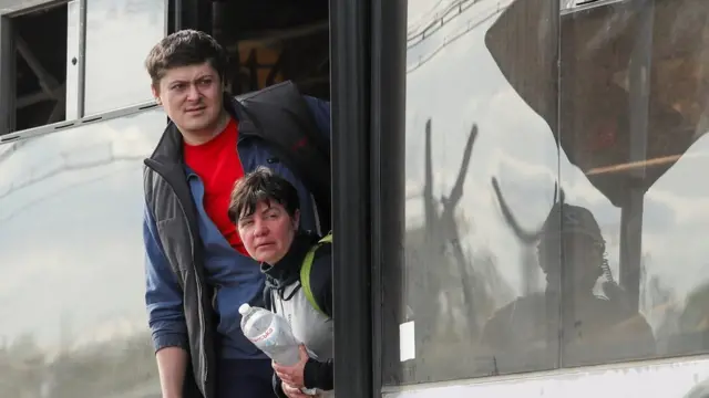 Civilians who left the area near Azovstal steel plant in Mariupol look out of a bus near a temporary accommodation centre during Ukraine-Russia conflict in the village of Bezimenne