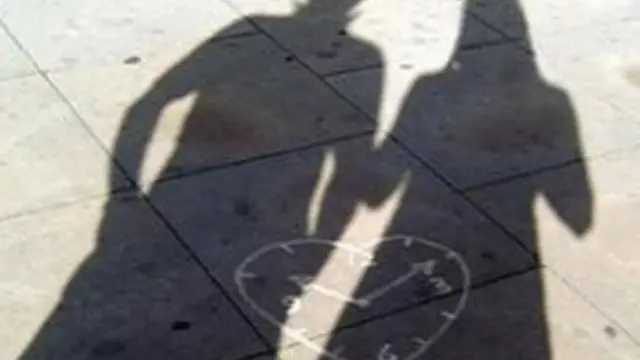 Silhouette of man and woman on a street