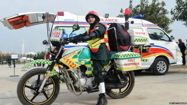 Pakistani first responder Samra Akram Zia poses for a photograph with her motorcycle ambulance service during a passing out ceremony in Lahore on February 24, 2018.