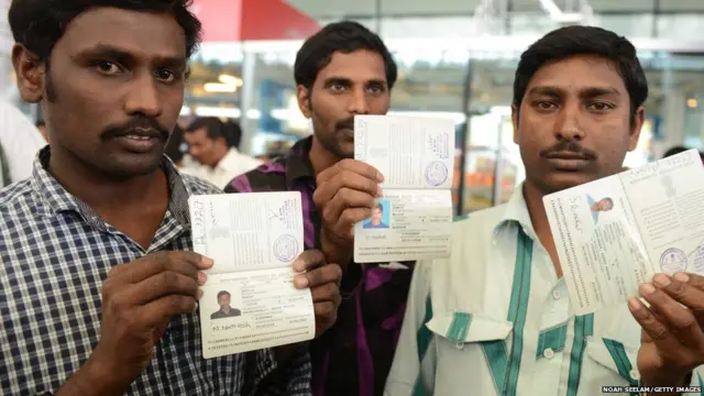 Indian workers returned from Iraq, show their passports to members of the media on their arrival at Rajiv Gandhi International Airport in Hyderabad on July 5, 2014.