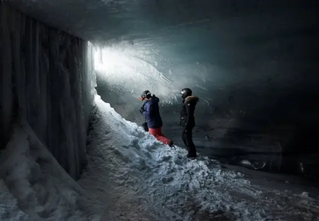 People stand in the "Mill" at the Glacier 3000 ski resort in Les Diablerets