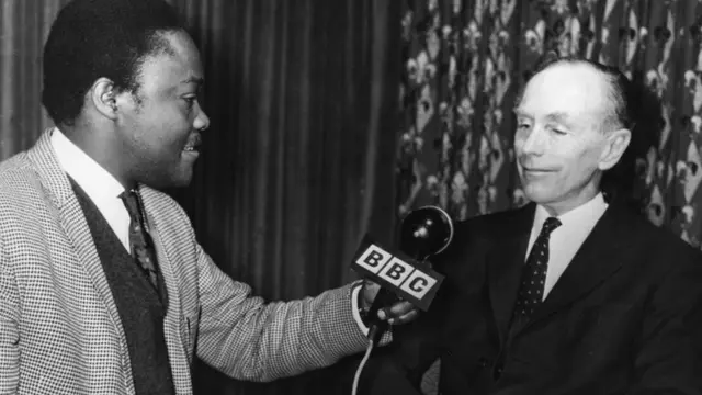 Sir Alec Douglas-Home, Britains Prime Mininster, is interviewed by Israel Wamala of Uganda for the BBC African Service programme, 'Focus on Africa', 1964