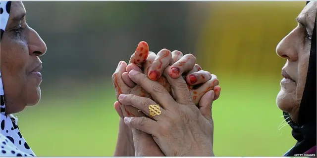 Sri Lanka Muslim women hug during Eid Al-Adha (Hajj festival) celebrations at the Galle Face esplanade in Colombo on October 6, 2014. Islam's second biggest annual festival Eid al-Adha is celebrated by Muslims worldwide to commemorate the willingness of Abraham to sacrifice his son as an act of obedience to God.