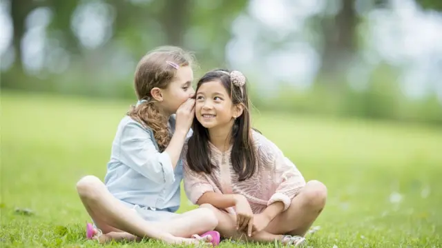 Girls whispering