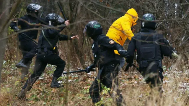 Police chase a demonstrator in Belarus on 22 November