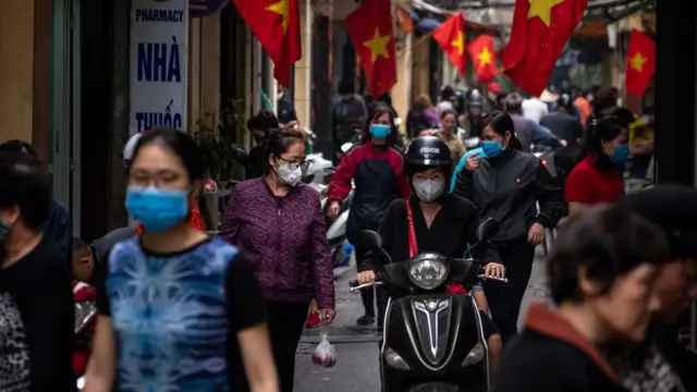 People wear facemasks in Hanoi