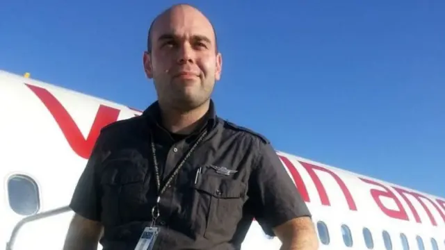 Bobby Laurie outside of Virgin Airways flight