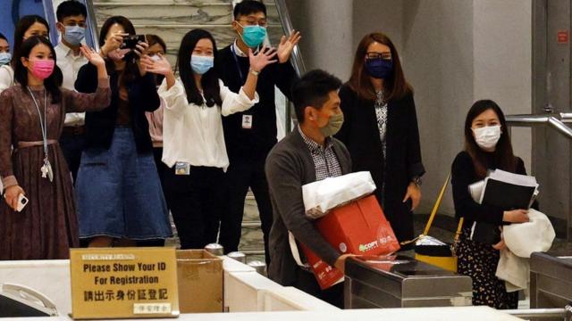i-Cable TV news journalists leave with their boxes after being laid off in Hong Kong, China December 1, 2020