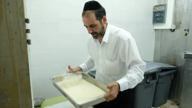 A Jewish supervisor checks food to ensure it is kosher