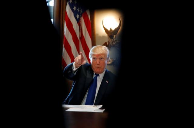 U.S. President Donald Trump talks with members of the press during a lunch with bicameral tax conferees in the Cabinet Room of the White House in Washington D.C., U.S. December 13, 2017. REUTERS/Carlos Barria TPX IMAGES OF THE DAY