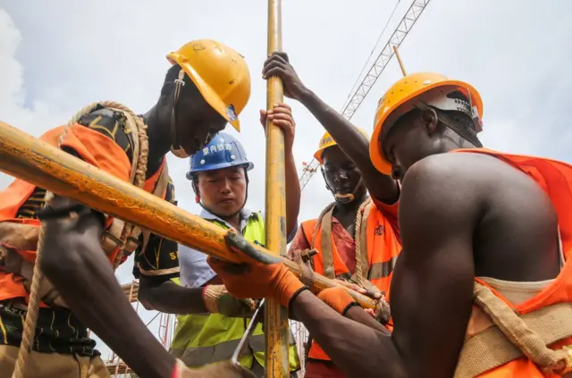 2016年4月9日,中國工程師張青春(左二)和肯方工人在在肯尼亞蒙內鐵路蒙巴薩西站工地上工作(資料照片)。