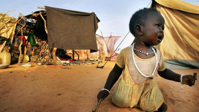 An infant refugee from the Darfur region of Sudan cries for her mother near her tent in the Oure Cassoni refugee camp, on August 31, 2004