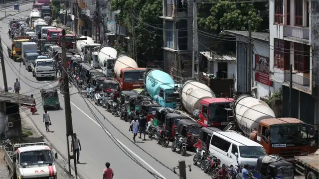 A long line of lorries and engine-powered rickshaws outside a filling station in Colombo, the Sri Lankan capital