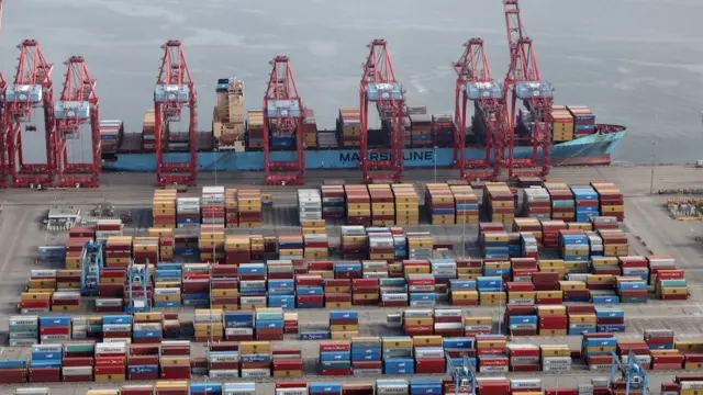 Shipping containers are unloaded from a ship at a container terminal at the Port of Long Beach-Port of Los Angeles complex, April 2021