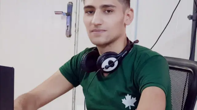 Mohammad at Zaatari camp at his laptop