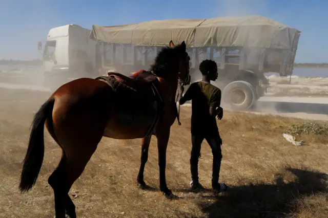 Fallou Diop walks with a young mare, called Raissa Betty, in Niaga, Senegal, 27 January 2021