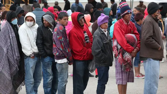 Fila de migrantes en un puesto fronterizo entre Estados Unidos y México.