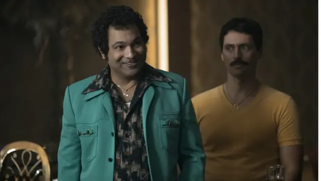 A scene out of the Netflix series showing two men in a meeting.